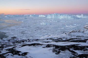 Giant icebergs floating in Ilulisat icefjord, Greenland. Massive icebergs, calved from the Sermeq Kujalleq Glacier, float through the Ilulissat Icefjord in western Greenland