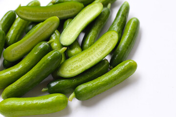 Fresh mini baby cucumbers on white background