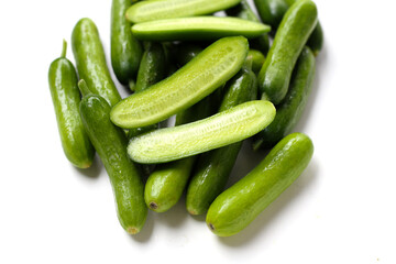 Fresh mini baby cucumbers on white background