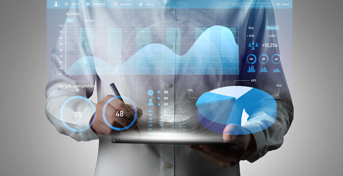 A modern business professional uses a tablet to visualize complex data analytics, showcasing interactive charts and performance metrics for effective decision-making. Impute