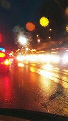 Blurred night city street lights on wet road