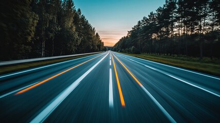 Highway through a forest at sunset, motion blur