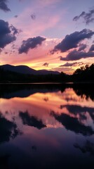 Sunset reflecting on a calm lake.  Silhouette mountains