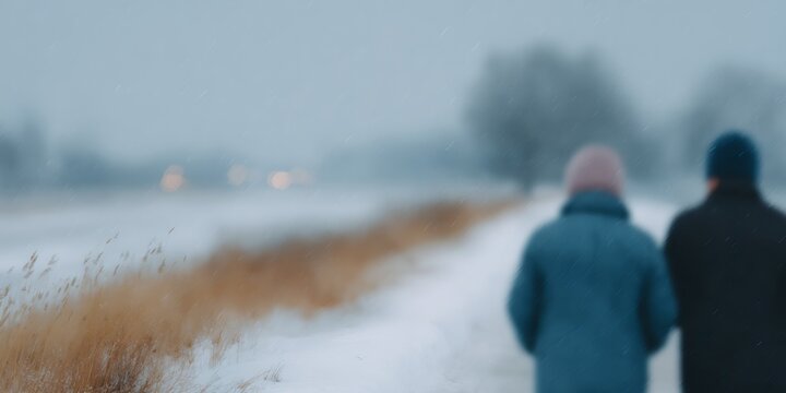 Two people walking in the snow