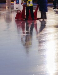 Ice skating on the ice rink arena with people, skating rink surface, ice skating in winter city, winter activities, holiday christmas time, with new year decoration and illumination, ice skates boots