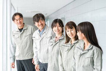 Fototapeta premium Male and female staff in the manufacturing, building, transportation and construction industries wearing work clothes 
