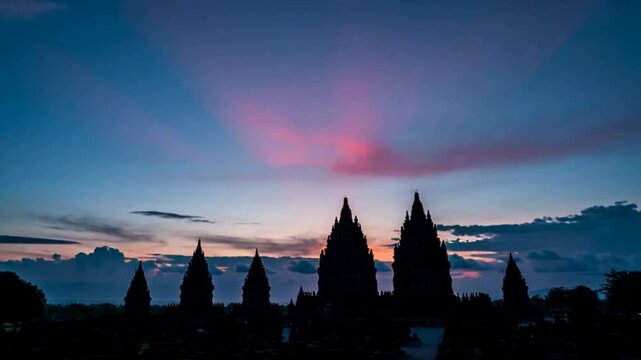 Stunning Sunset Over Ancient Temples Silhouetted Against Vibrant Sky.