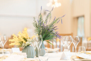 Floral decorations on tables at a wedding reception
