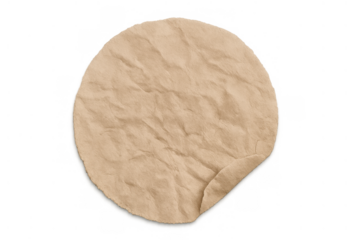 Round crumpled brown kraft paper sticker with curled edge, isolated on transparent background, for branding or message