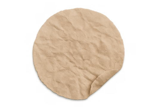 Round crumpled brown kraft paper sticker with curled edge, isolated on transparent background, for branding or message