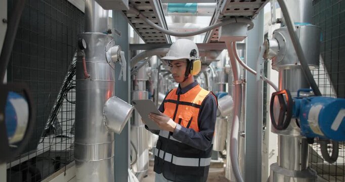 HVAC technician use tablet to record data and conduct real-time analysis. Using specialized software to diagnose and optimize mechanical, electrical, and plumbing systems with energy efficiency plan
