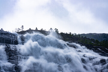 Powerful white water waterfall rushing over rocks © Janica