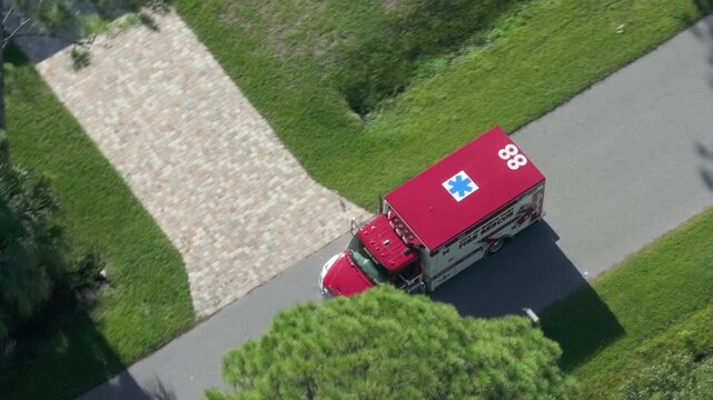 Fire rescue truck drive on Florida road. Emergency service vehicle on city street in USA.