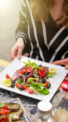 Enjoying a lunch outdoors at an Italian restaurant with traditional dishes on the table