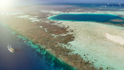 Scenic aerial landscape of Pulau Karangan Komodo highlighting coral reef and clear tropical sea