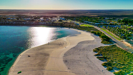 Aerial view of Coral Bay and beach in Western Australia with turquoise ocean and white sand