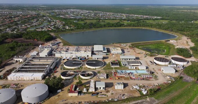 Large-scale industrial water treatment plant purifying and recycling water through filtration and chemical processes to meet health and safety standards.
