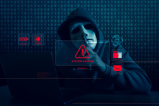 Cyber attack. Anonymous hacker with laptop showing hush gesture, binary code behind him. Virtual screen with warning sign