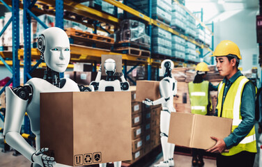Innovative industry robot working in warehouse together with human worker . Concept of artificial...