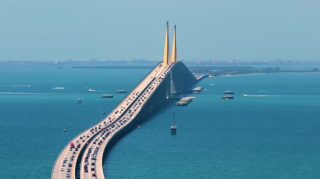 Sunshine Skyway Bridge over Tampa Bay in St Petersburg in Florida with driving traffic cars. Transportation infrastructure in USA