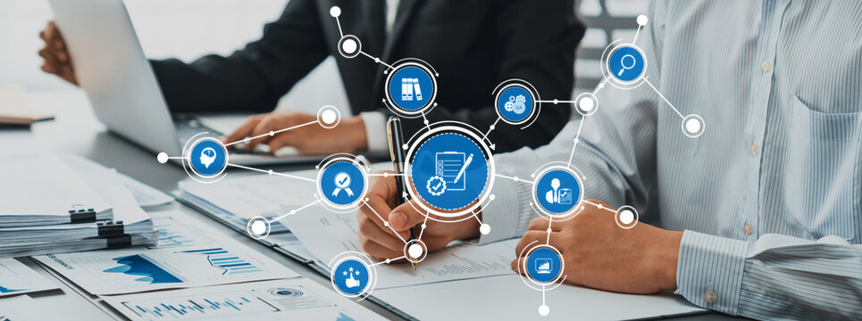 This image showcases a professional setting where individuals collaborate on digital data related to e-commerce, surrounded by charts and icons that reflect strategy and analysis. Amity
