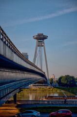 Bratislava, Slovakia – July 24, 2025: The UFO Observation Tower atop the SNP Bridge spans the...