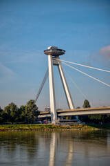 Bratislava, Slovakia – July 24, 2025: The UFO Observation Tower atop the SNP Bridge spans the...