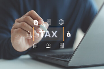 Businessman using digital interface to manage online tax payment, financial data and accounting information on laptop. Concept of digital taxation, e-filing and financial management technology.