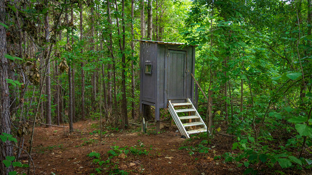Wooden hunting blind in lush forest ready for opening day of deer season in deep in the piney woods