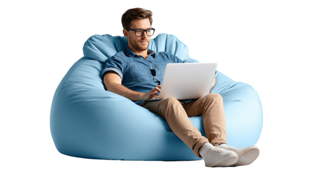 Man working on laptop in beanbag chair: A focused man with glasses engrossed in his laptop sits comfortably in a plush beanbag chair, presenting an image of relaxed productivity and modern living. - Powered by Adobe