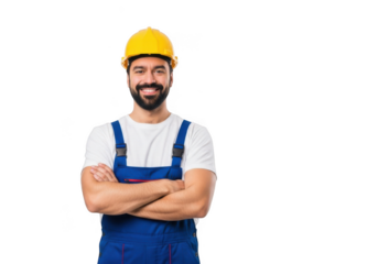 A smiling construction worker wearing a yellow hard hat and blue overalls with arms crossed isolated on transparent background