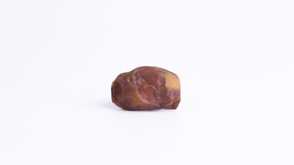 Single Sukkari date fruit on a clean white background with ample copy space. Represents healthy Iftar food, Ramadan snack, natural sugar, organic ingredients, and Middle Eastern dessert.
