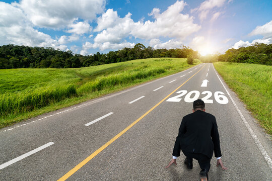 2026 New Year journey and future vision concept . Businessman traveling on highway road leading forward to happy new year celebration in beginning of 2026 for glee and successful start .