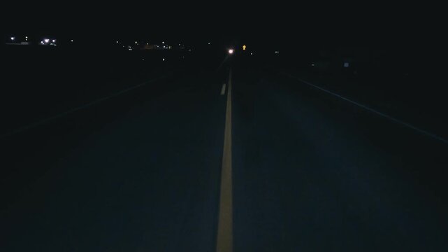 POV in the car, driving on a dark empty road, highway in the middle of the night