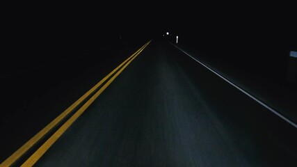 POV in the car, driving on a dark empty road, highway in the middle of the night