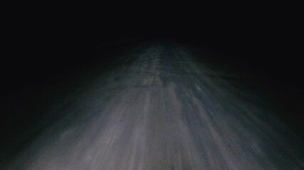 Driving on a Dirt Road at Night, Alone in the Dark Desert