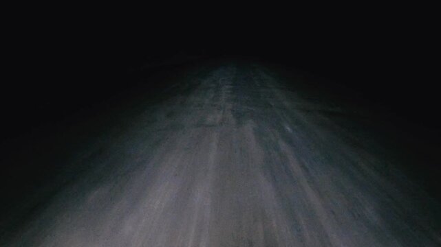 Driving on a Dirt Road at Night, Alone in the Dark Desert