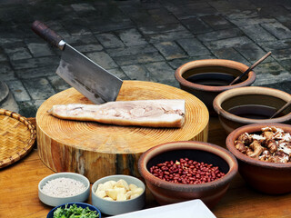 Boiled pork trotters on a cutting board in a kitchen in Bobai, Guangxi, China.