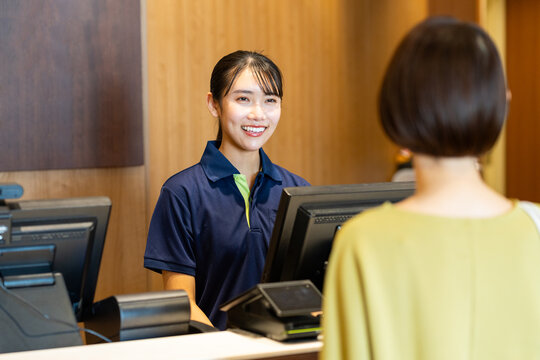 ジムで受付の仕事をする若い女性　撮影協力：スポーツクラブ&サウナスパ ルネサンス 幕張24