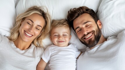 Fototapeta premium A happy family of three smiles while lying on a bed, radiating joy and warmth in a cozy environment.