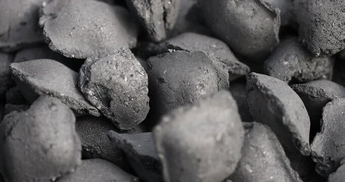 charcoal compressed from crumbs is obtained under pressure and used to light a fire and cook food on the grill, black charcoal in briquettes for barbecues