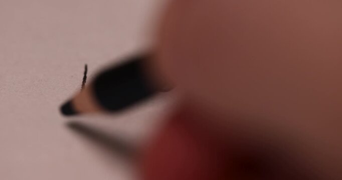 drawing on paper with a wooden pencil with a black lead, cross out the word love written in black pencil on paper