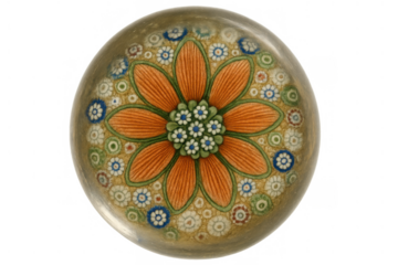 Millefiori glass paperweight showcasing an intricate orange flower design with blue and white floral details, transparent background