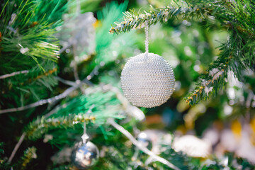 A beautifully decorated Christmas tree adorned with shiny ornaments and festive baubles, symbolizing the joyful spirit of the holiday season.