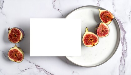 Elegant fig flat lay with blank card on marble background.