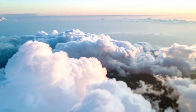 Aerial view of soft clouds glowing in sunrise light. Peaceful atmosphere with pastel tones and layered formations in the sky. - Powered by Adobe