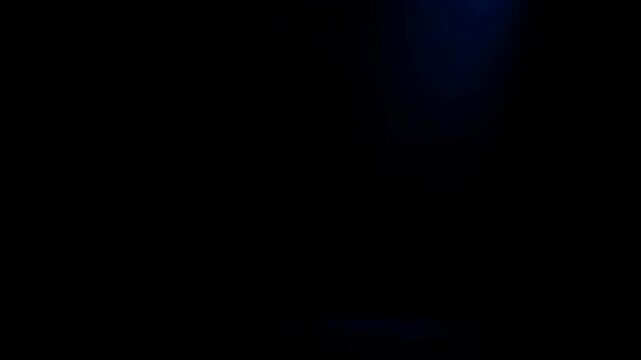 Mysterious Blue Light Beam Illuminates Dark Stage Creating an Atmospheric Glow