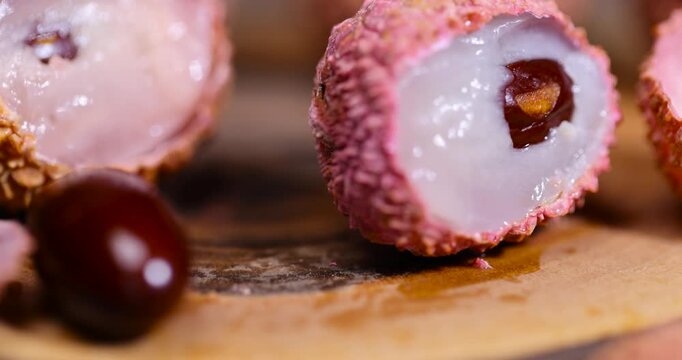 ripe lychee fruits with cut pink tough peel, cooking lychee close up