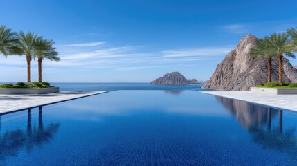 Fototapeta premium High Angle Photo Of An Infinity Edge Pool With Blue Water And Palm Trees Overlooking The Ocean With Rocky Islands In The Distance Under A Clear Blue Sky