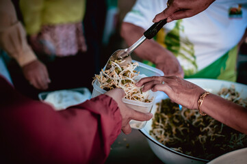 The hands of the hungry are asking for food from the donor,Out to the Homeless and Hungry